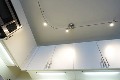 This picture shows track lighting installation in Tallahassee. Lights are in the kitchen above and under the cabinets.